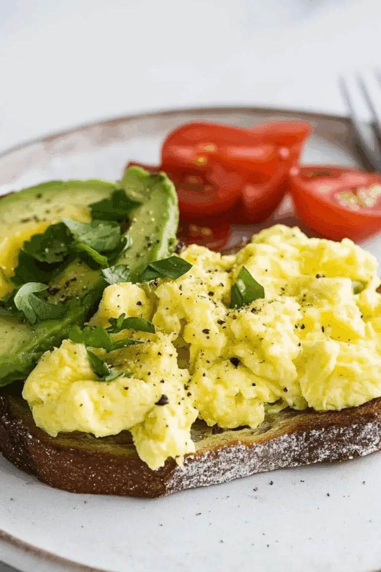 Avocado Toast with Scrambled Egg served on toasted sourdough bread