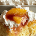 Peaches and Cream Poke Cake with fresh peaches and whipped topping