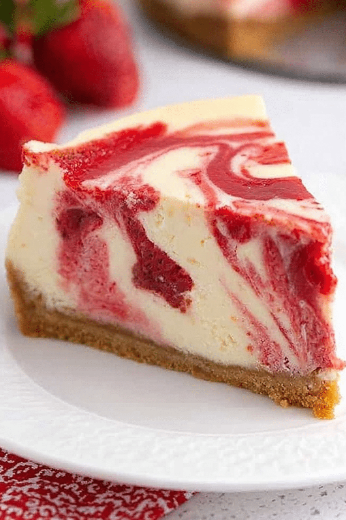 Strawberry swirl cheesecake with creamy filling and graham cracker crust