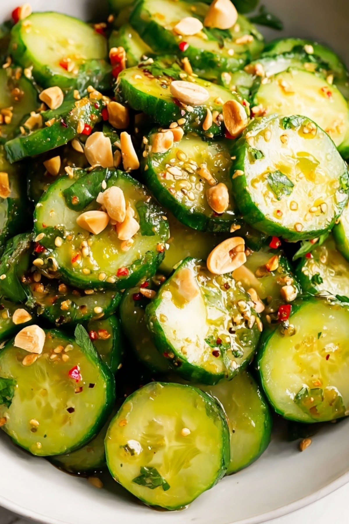 Asian cucumber salad with fresh cucumbers, peanuts, and sesame seeds
