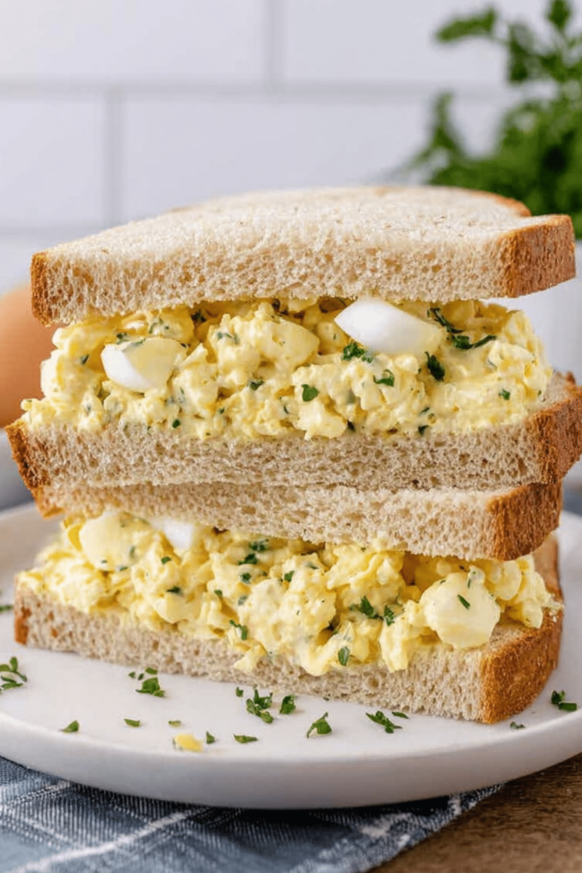classic egg salad sandwich on white bread with creamy texture