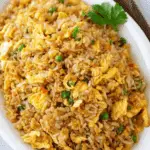 Egg fried rice served in a wok with eggs, green onions, and soy sauce