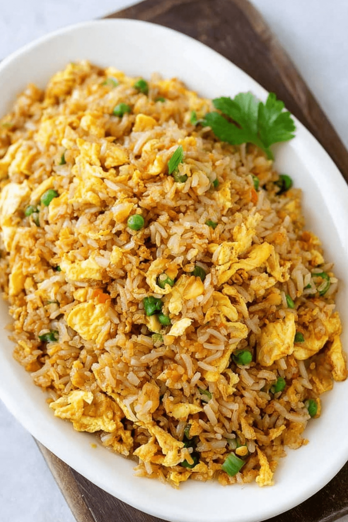 Egg fried rice served in a wok with eggs, green onions, and soy sauce