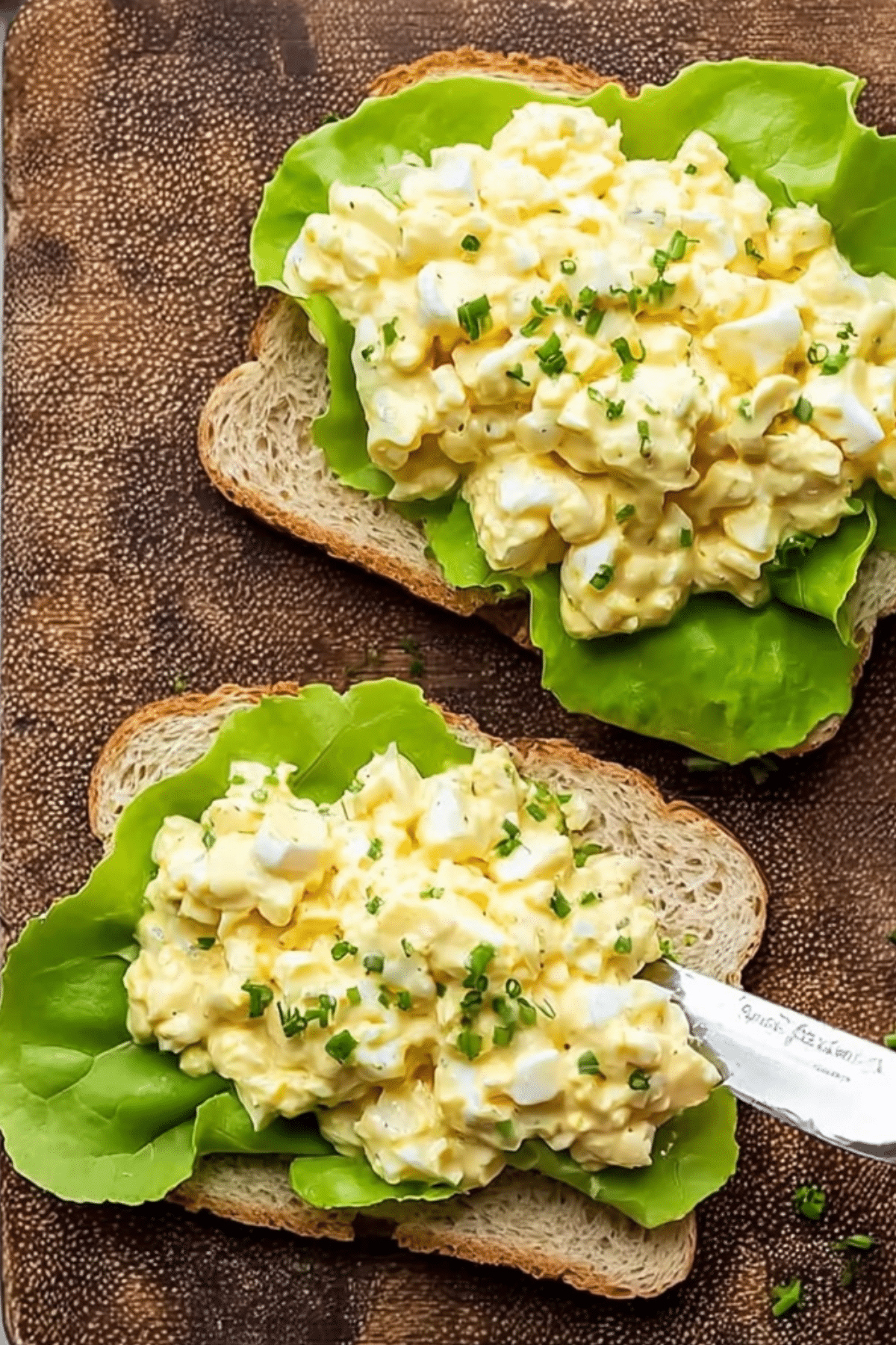 Egg salad sandwich served on toasted bread with fresh lettuce