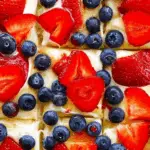 Fruit pizza with fresh fruit toppings on a sugar cookie crust