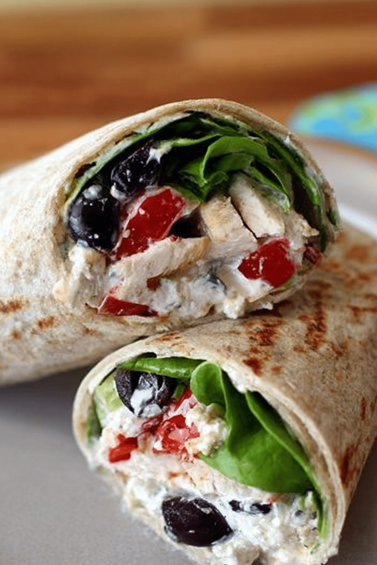 Mediterranean Chicken Wraps served in tortillas with arugula and feta