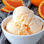 Orange Creamsicle Ice Cream served in a bowl with orange slices