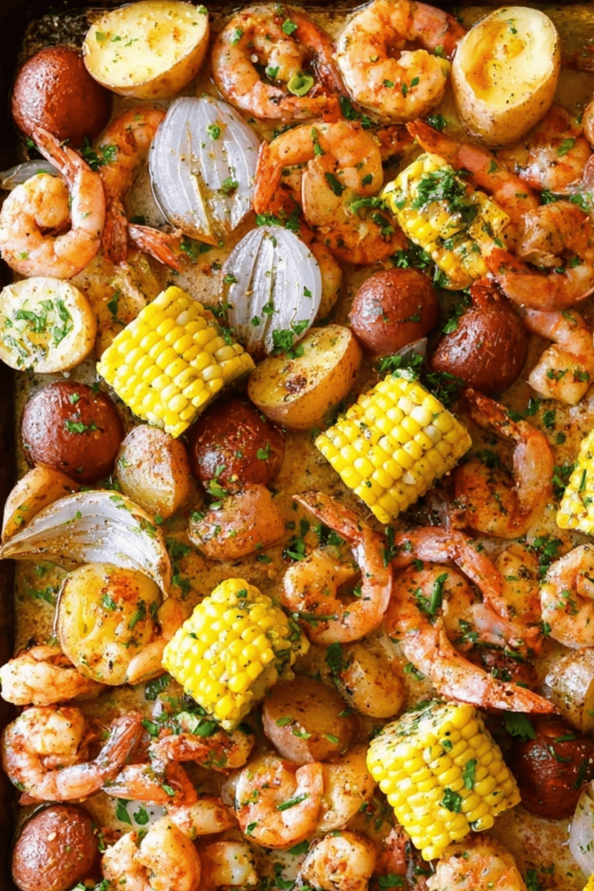 Sheet Pan Shrimp Boil with shrimp, sausage, corn, and potatoes on a baking sheet