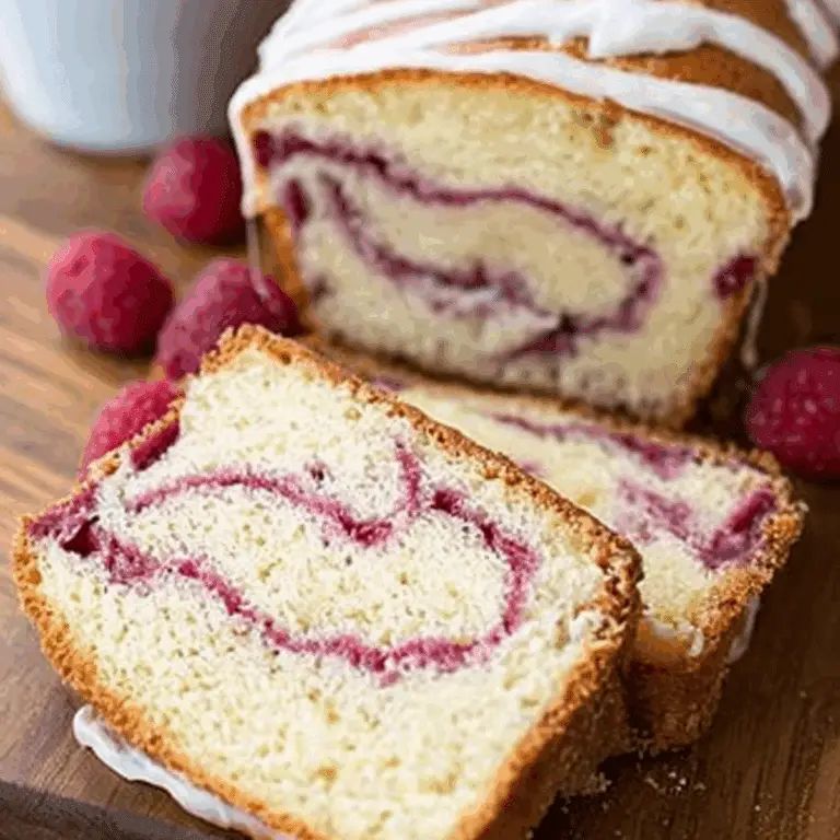 Yogurt Cake with Raspberry Swirl topped with a creamy glaze