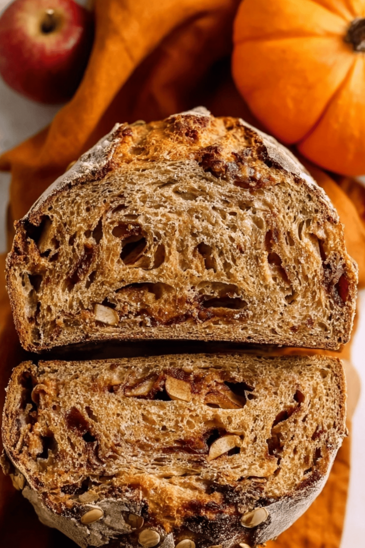 Sourdough Pumpkin Apple Bread with cinnamon and pecans on rustic board