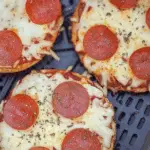 Air Fryer Bagel Pizzas with melted cheese and toppings