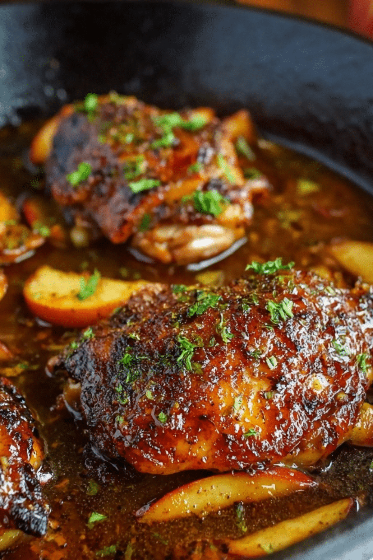 Apple Cider Glazed Chicken served with fresh herbs and apples