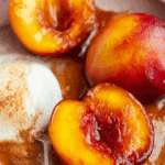 Baked nectarines with cinnamon honey sauce and vanilla ice cream
