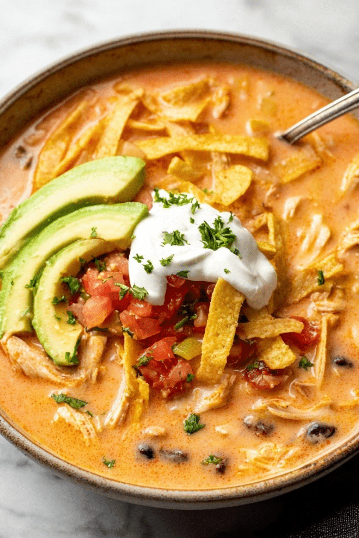 Creamy Chicken Tortilla Soup in a bowl with toppings