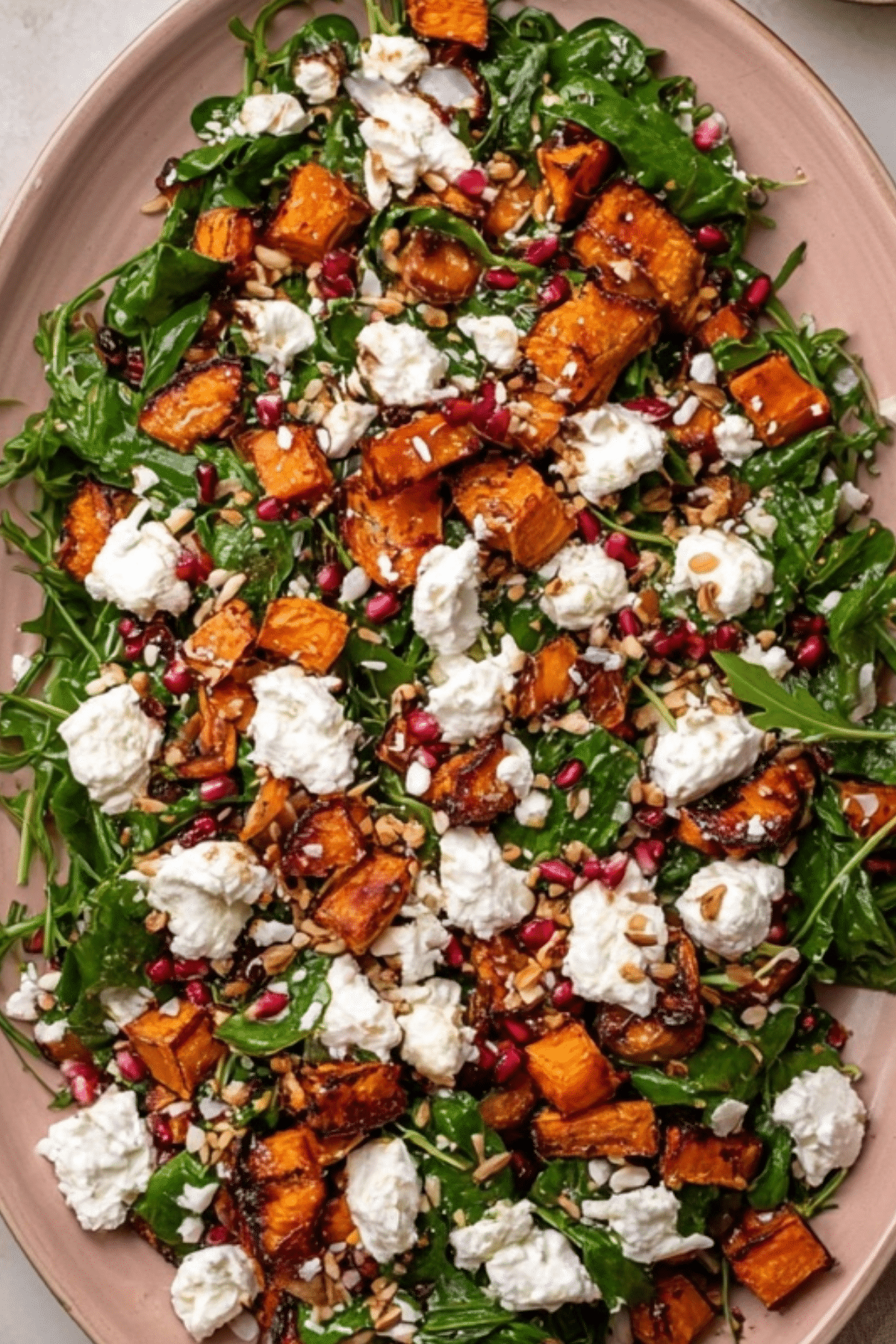 Roasted Sweet Potato Goat Cheese Salad with arugula, pomegranate, and pine nuts"