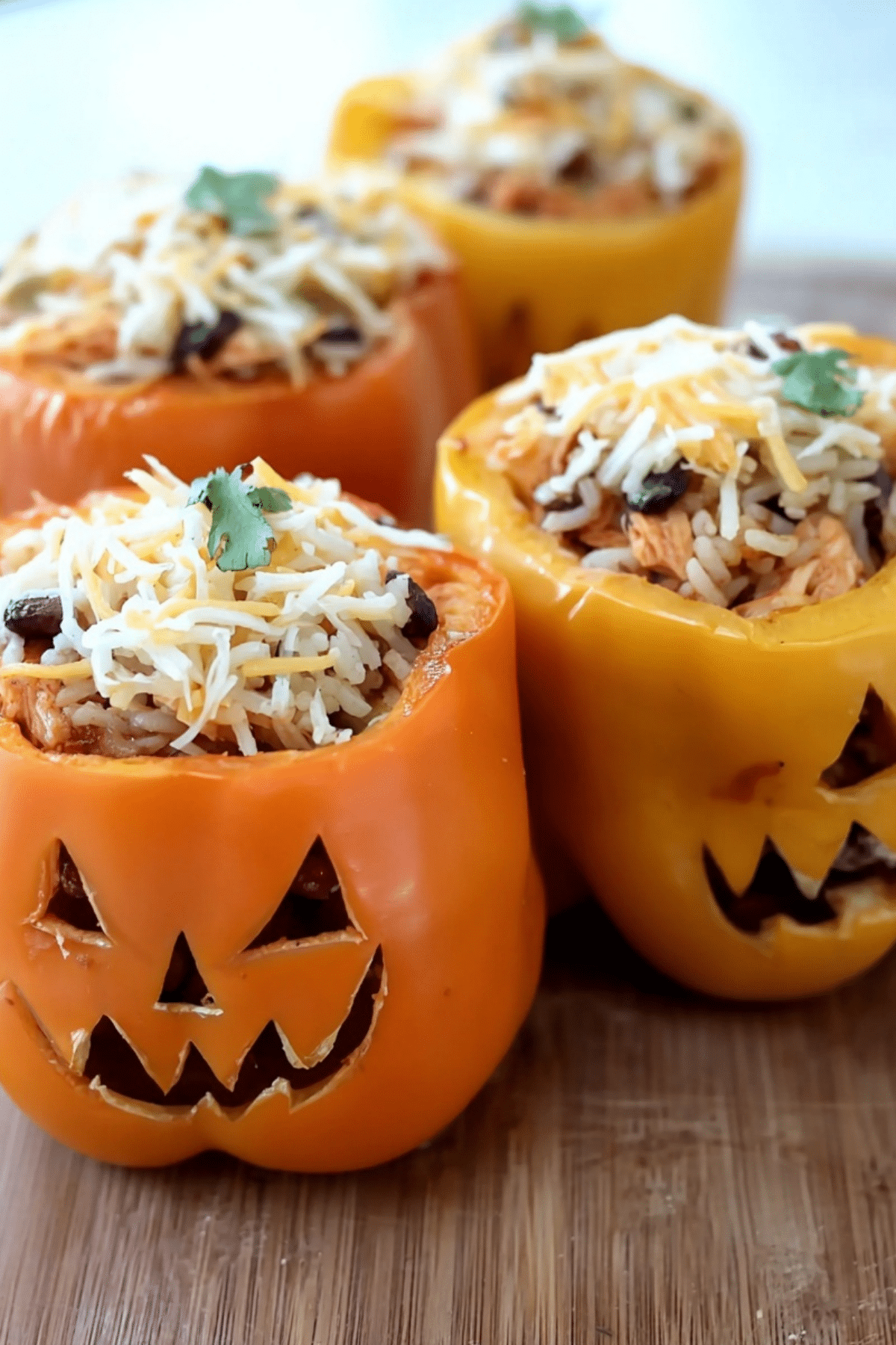 Shredded Chicken & Rice Stuffed Peppers on a plate with melted cheese