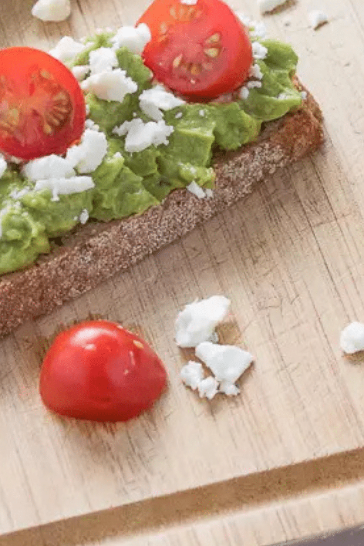Avocado and Feta Toast on whole grain bread with tomatoes and feta