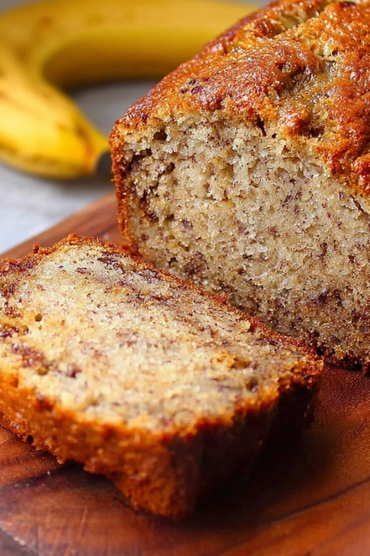 classic banana bread loaf on a plate with slices