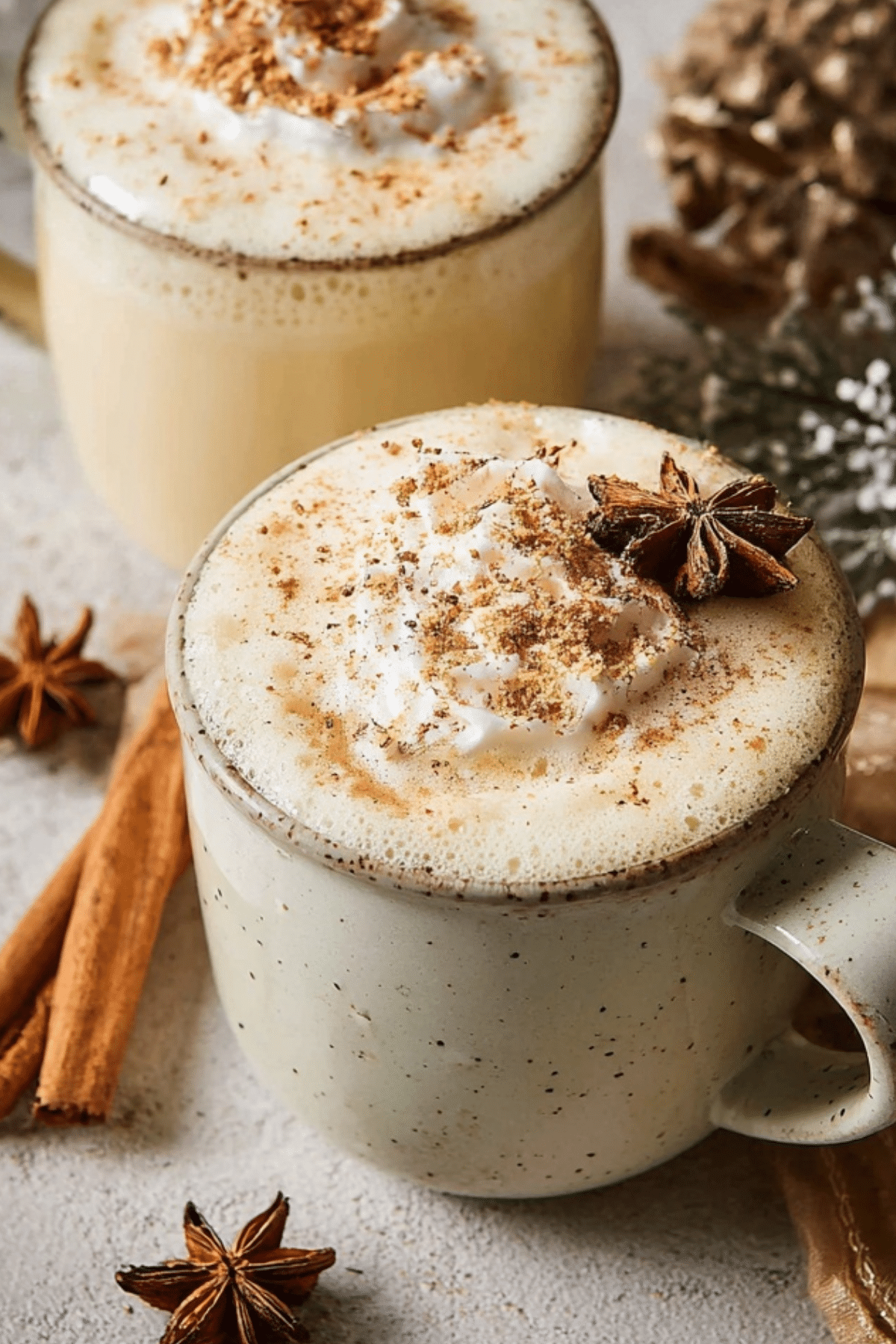 Cozy Eggnog Latte with whipped cream and cinnamon topping