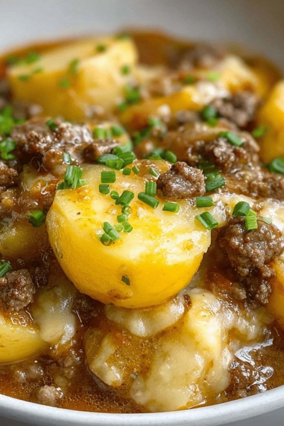 Crockpot Hamburger Potato Casserole with ground beef, potatoes, and melted cheese