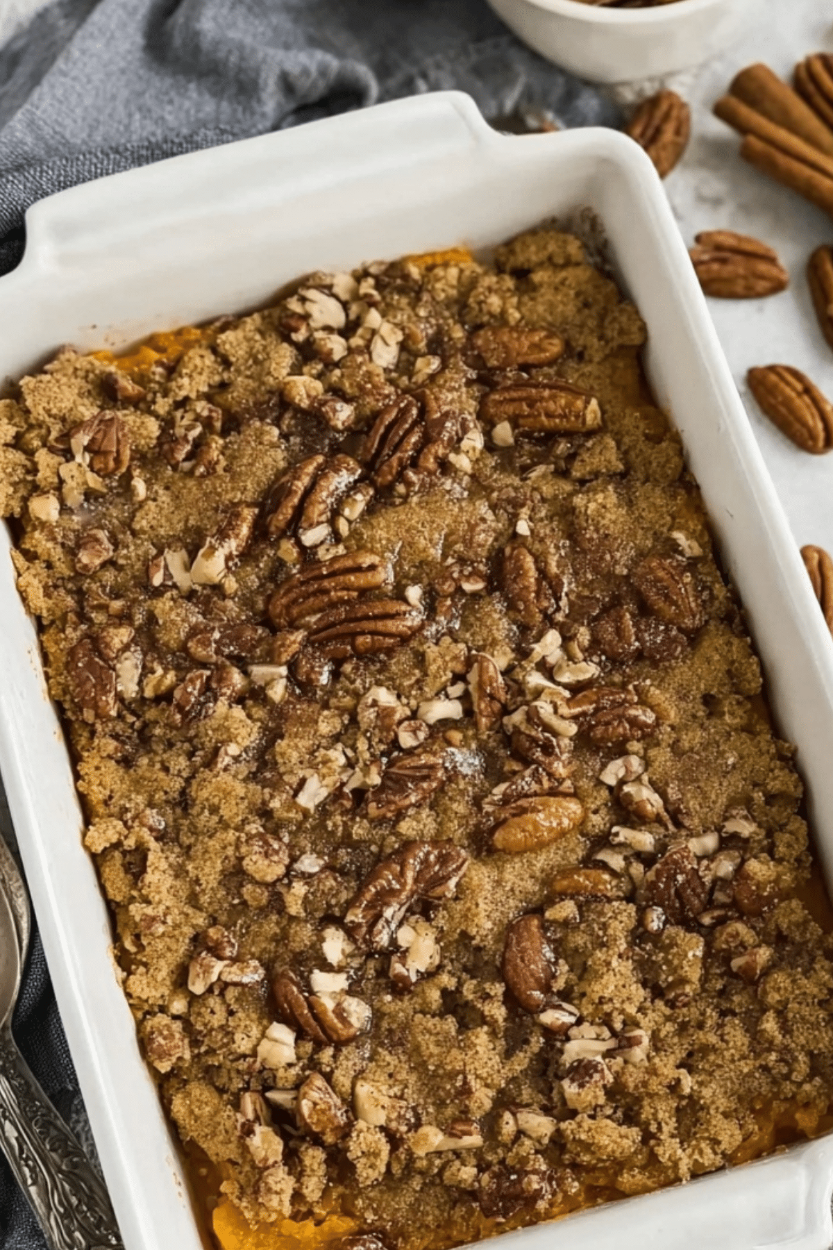 Sweet Potato Casserole with Pecans in a baking dish, topped with crunchy pecans