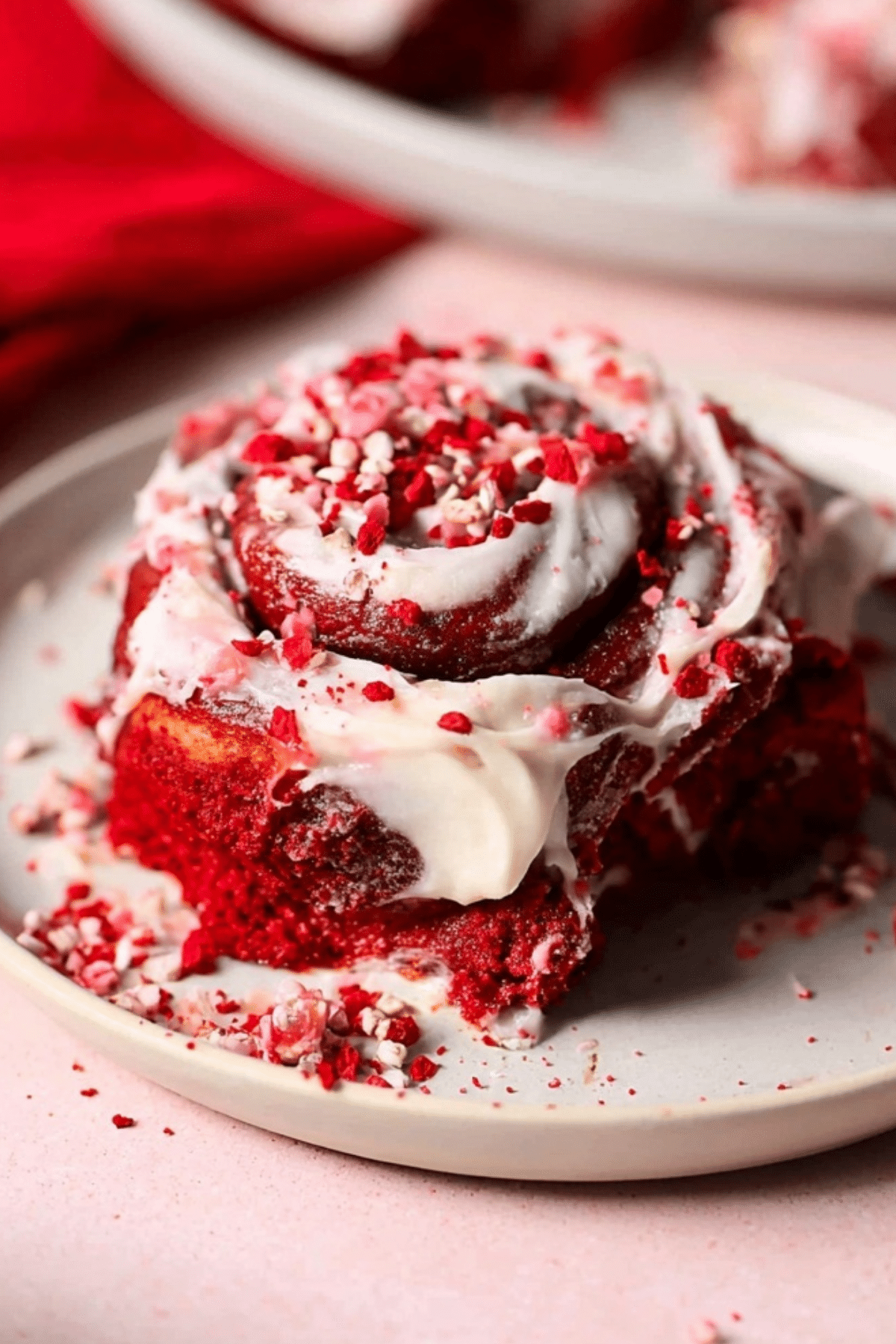 Red Velvet Cinnamon Rolls with Cream Cheese Frosting on a plate
