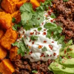 Sweet Potato Taco Bowl with roasted sweet potatoes, taco beef, and fresh toppings.