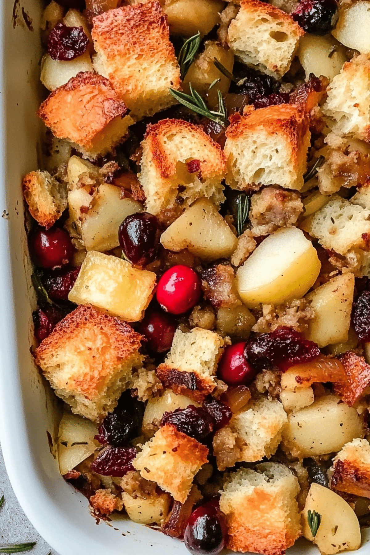 Apple Cranberry Stuffing in baking dish with golden crisp top