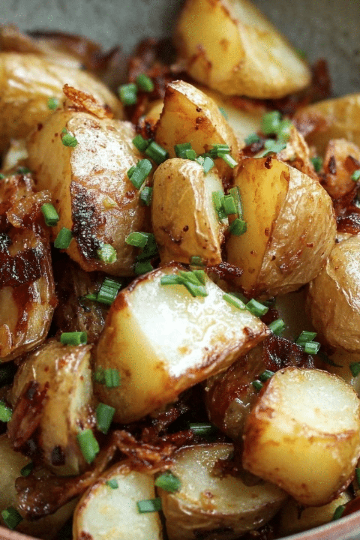 Bangin’ Breakfast Potatoes served in a skillet with bacon and herbs