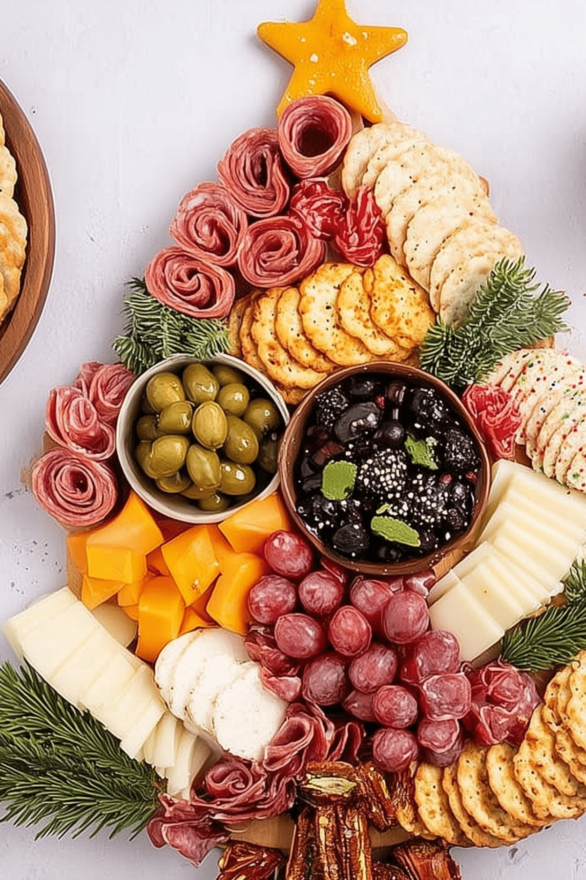 Christmas Tree Charcuterie Board with meats, cheeses, and festive toppings
