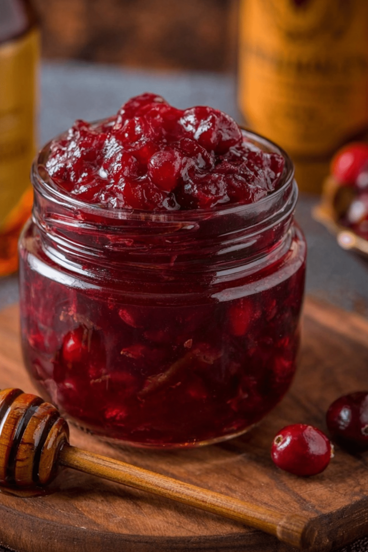 Honey Bourbon Cranberry Sauce served in a bowl with ingredients around it