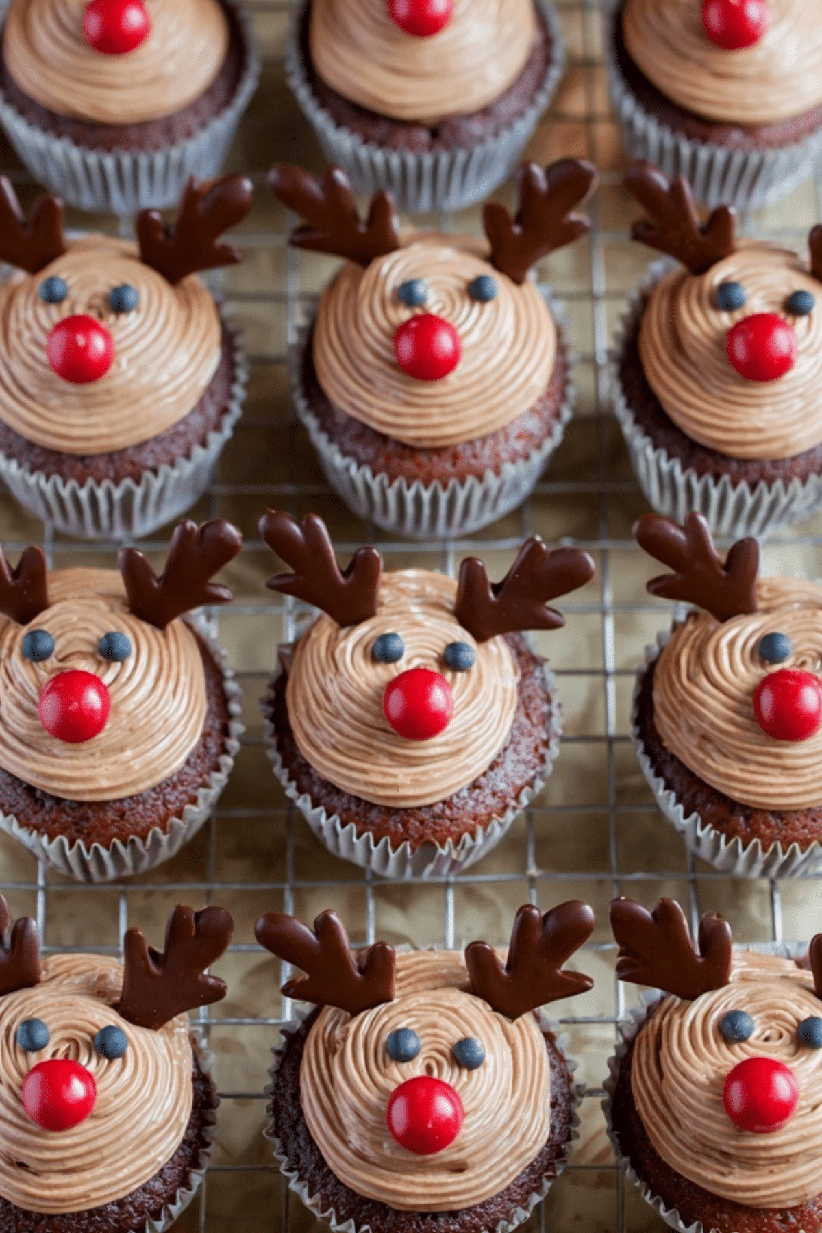 Decorated Reindeer Cupcakes with chocolate antlers and red noses