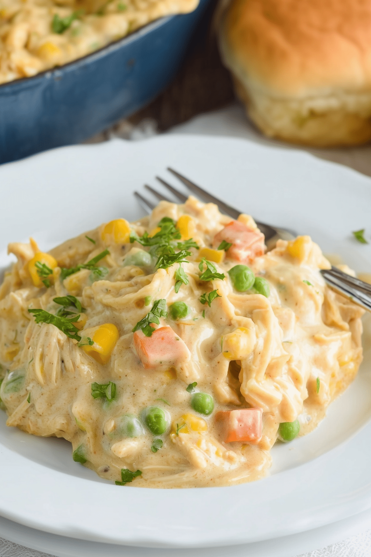 chicken pot pie casserole with golden biscuits and creamy filling