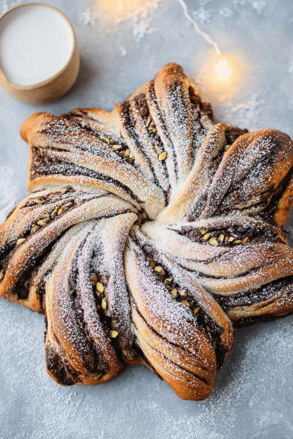 Chocolate Pistachio Christmas Star Bread with powdered sugar and vanilla dip