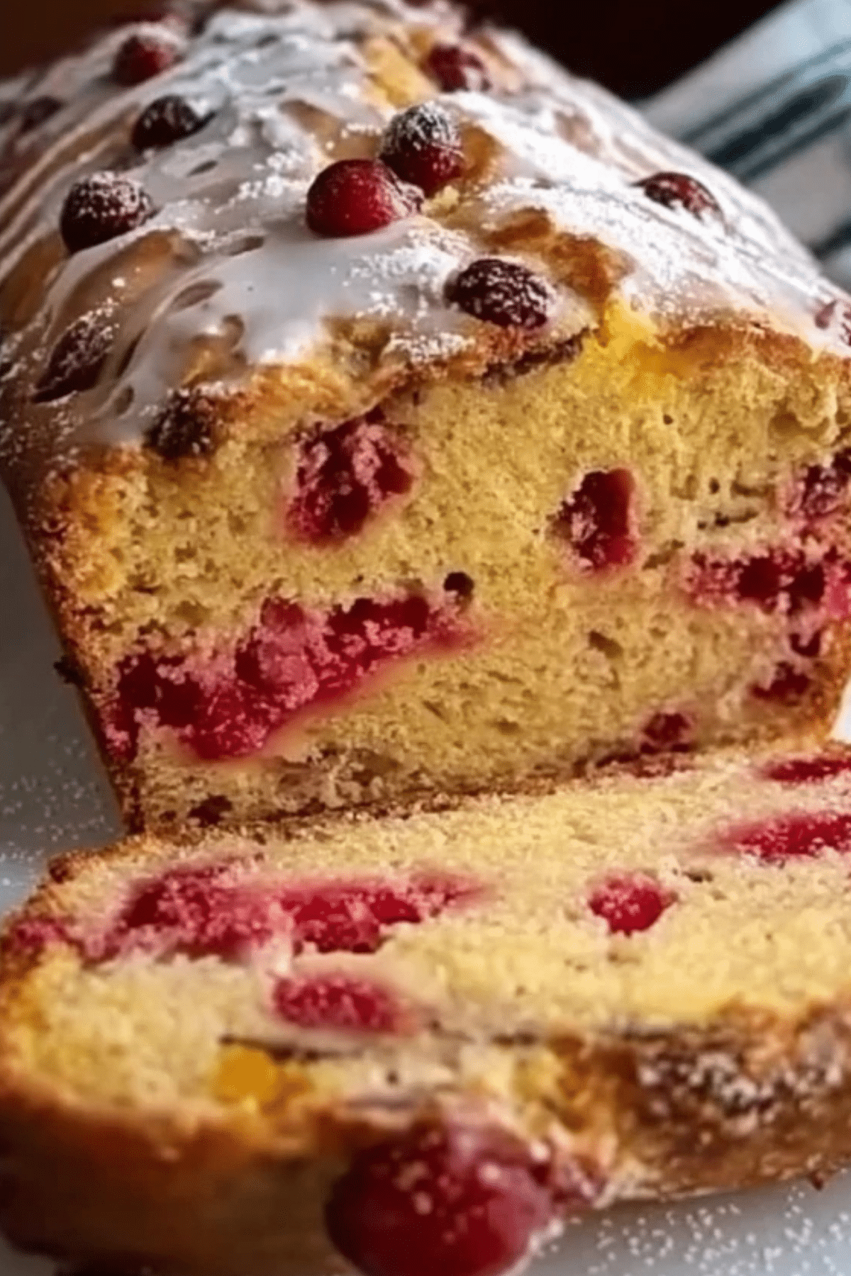 freshly baked cranberry orange loaf on a cooling rack