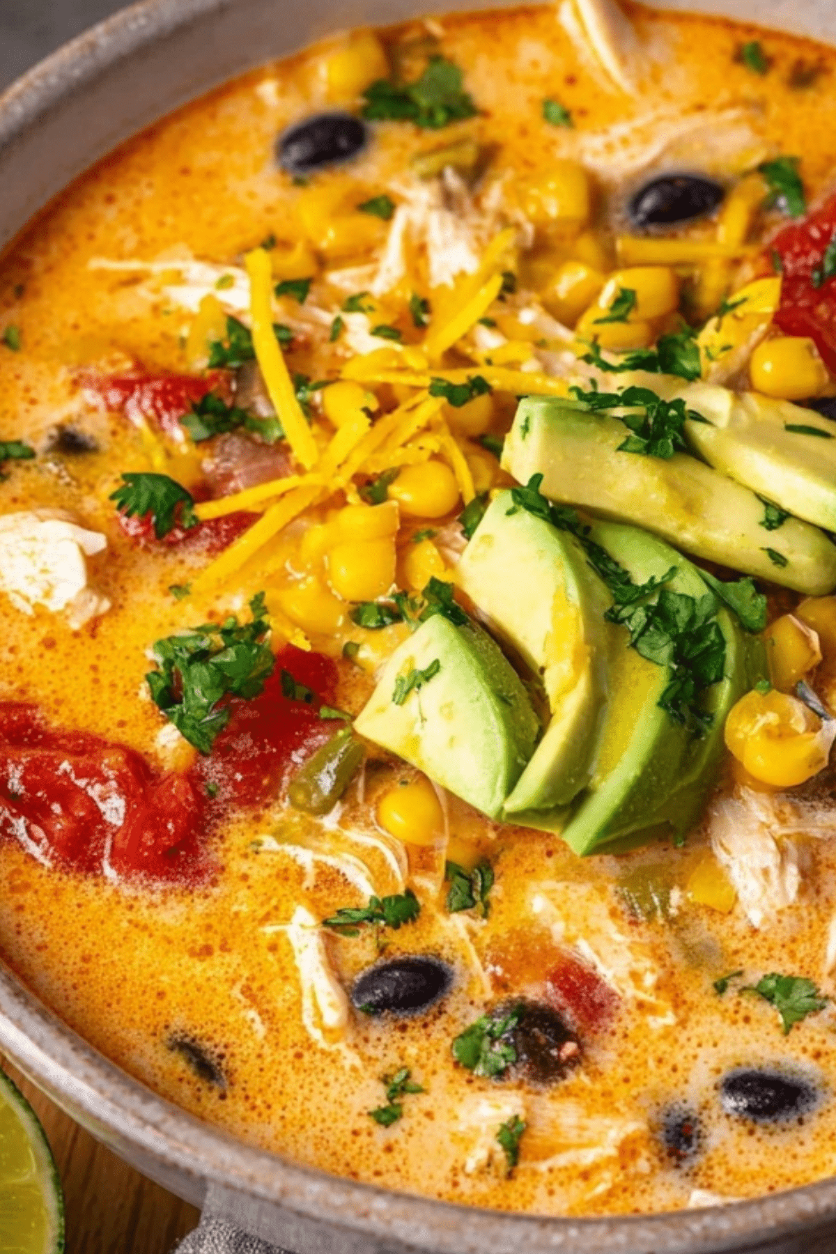 Creamy Chicken Enchilada Soup served with toppings