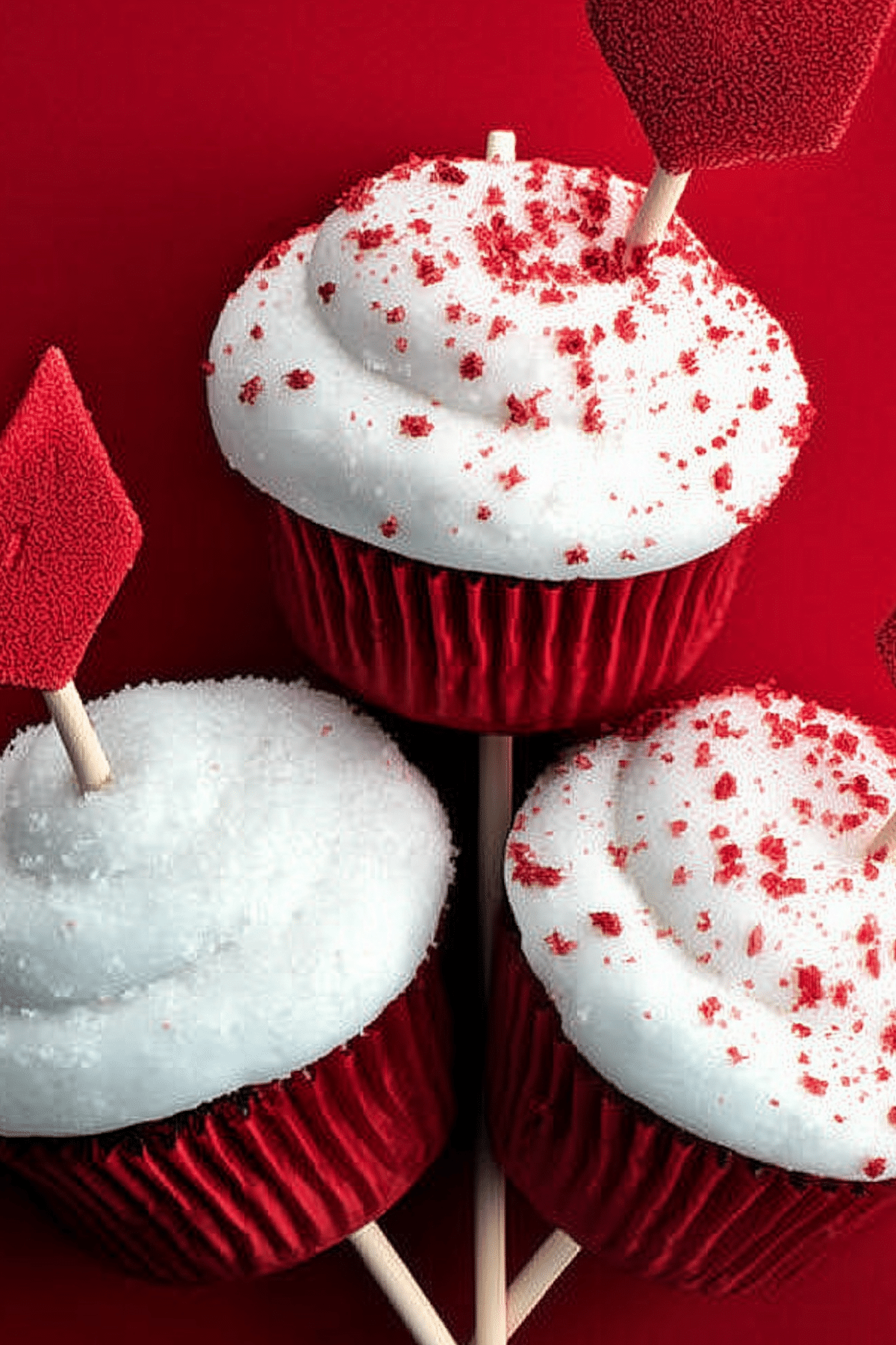 Cupid’s Arrow Cupcakes decorated with cream cheese frosting and heart-shaped paper arrows.