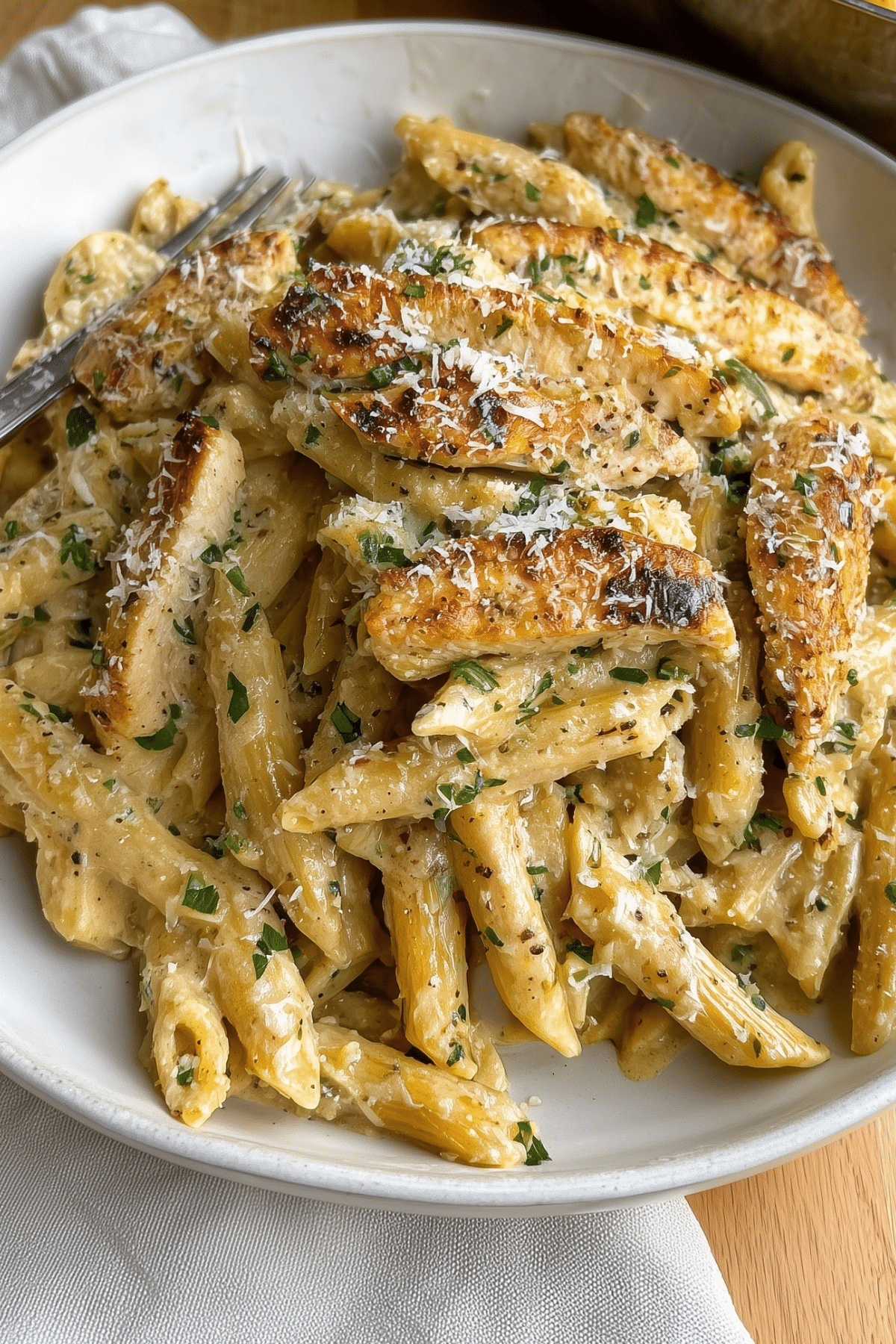 Garlic Parmesan Chicken Pasta in creamy sauce with sliced chicken