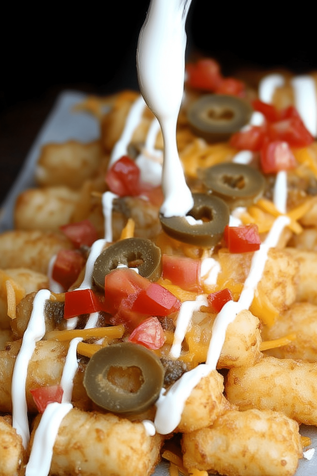 Loaded Tater Tot Nachos with cheese, bacon, and fresh toppings