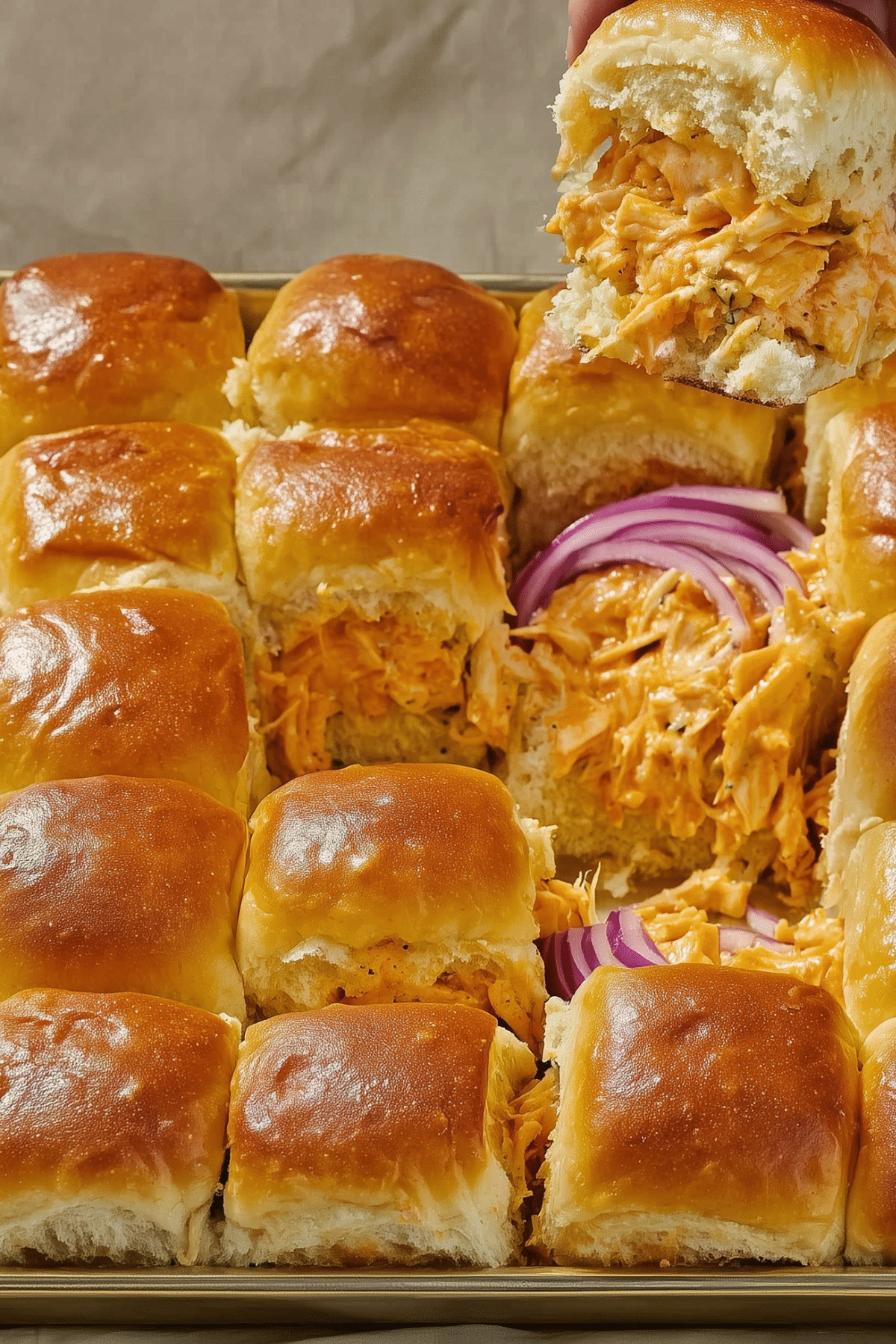 Sheet Pan Buffalo Chicken Sliders with melted cheese and buffalo sauce