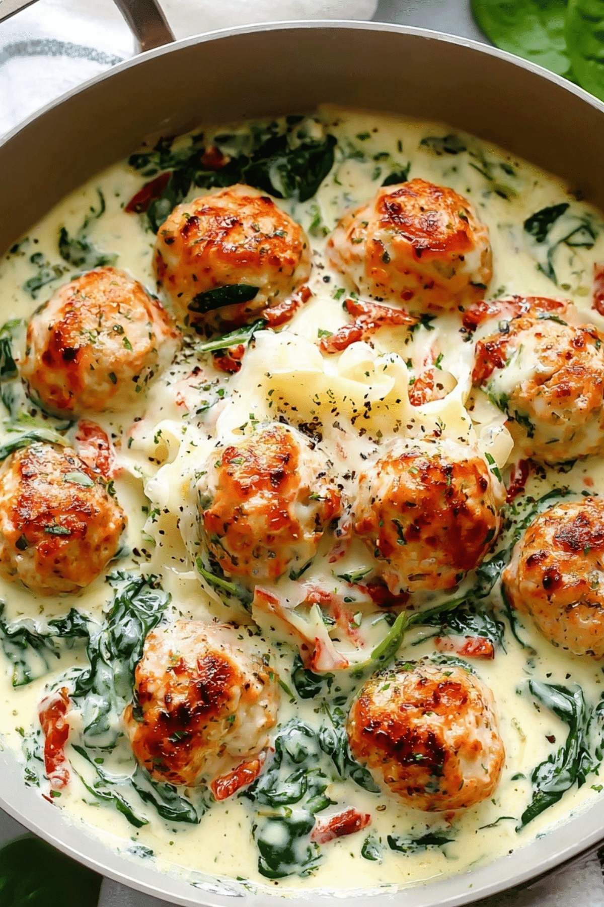 Baked Chicken Ricotta Meatballs with Spinach Alfredo Sauce served with creamy pasta