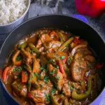 Braised veal and peppers served with tomato sauce and peppers