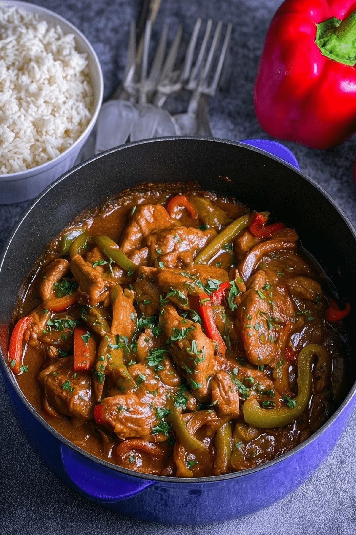 Braised veal and peppers served with tomato sauce and peppers