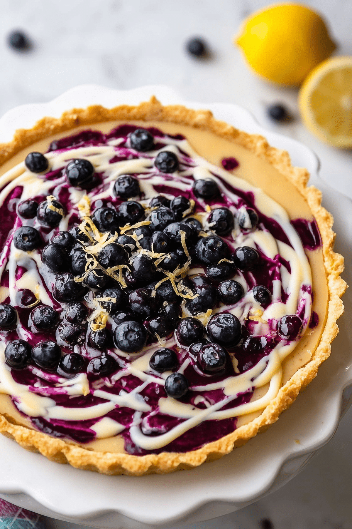 Lemon Blueberry Tart with creamy lemon filling and blueberry swirl