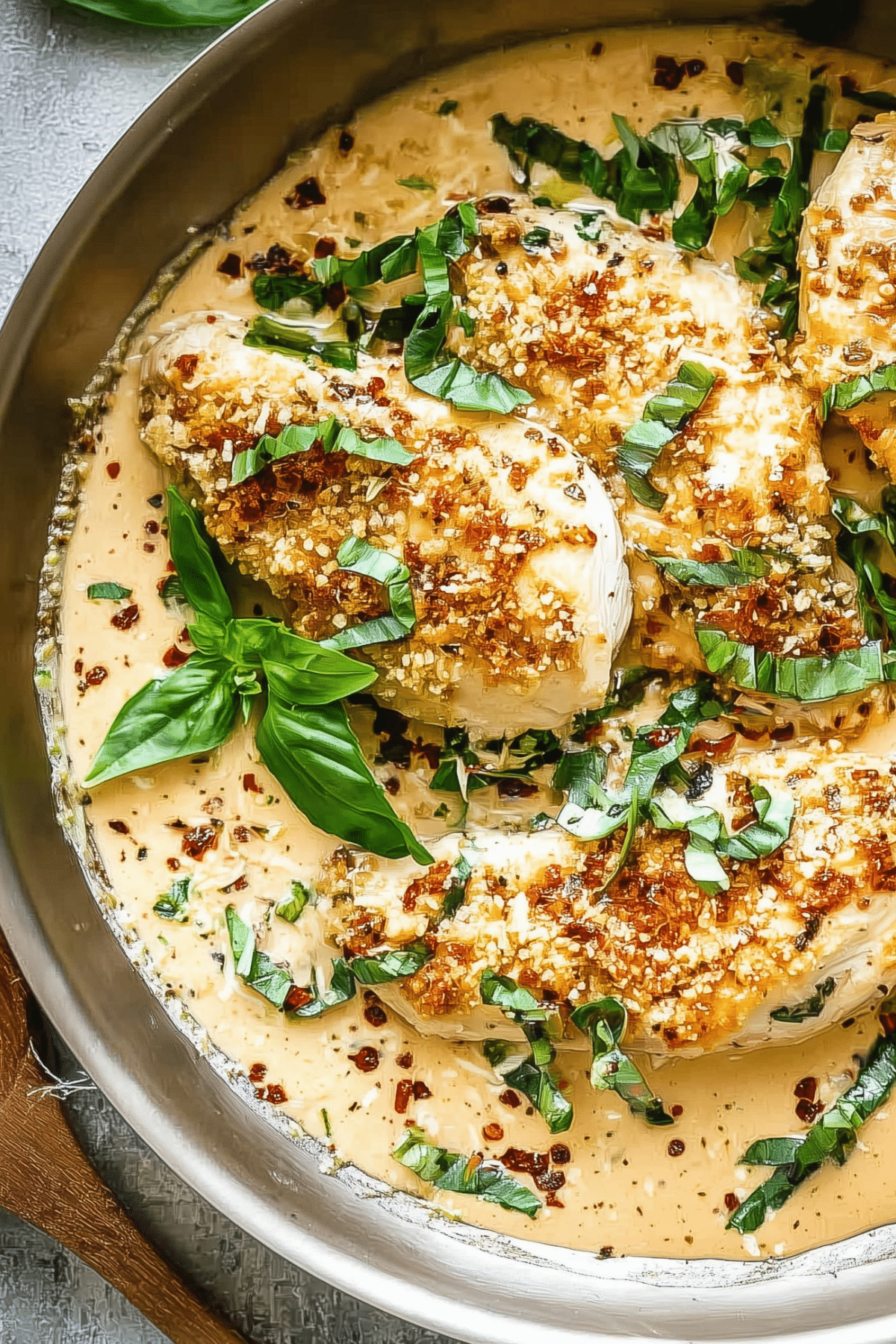 creamy parmesan basil chicken with fresh basil garnish