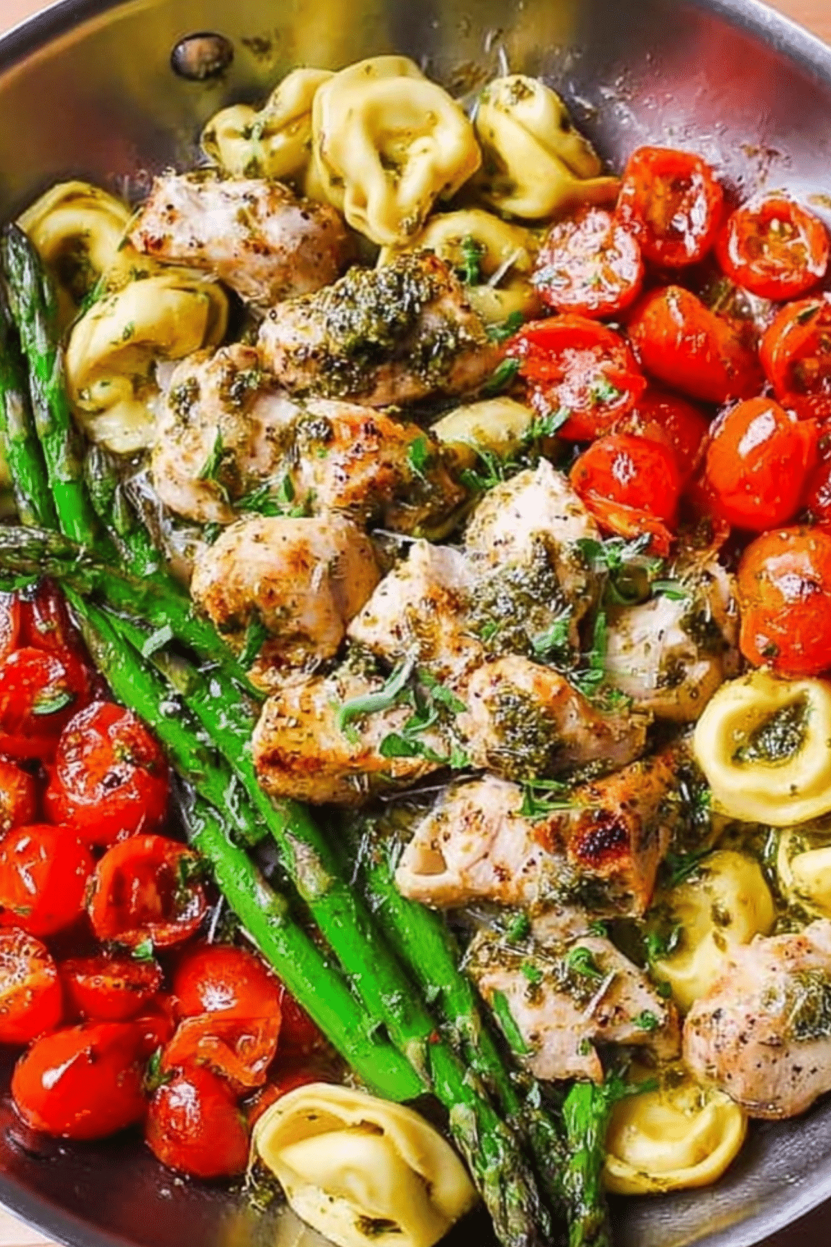 Pesto Chicken Tortellini and Veggies served with asparagus and tomatoes