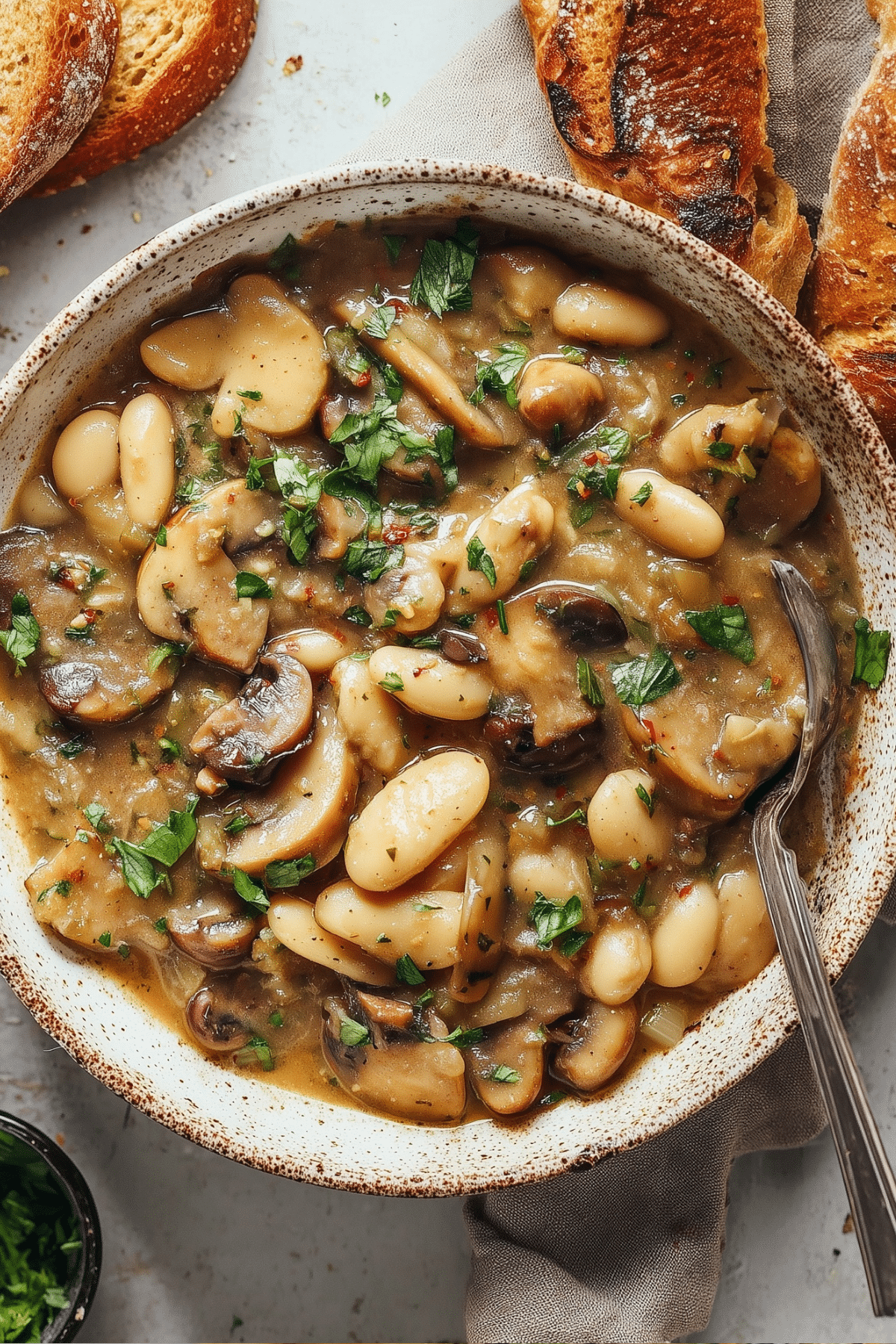 White bean mushroom stew in a pot, creamy and hearty vegan recipe