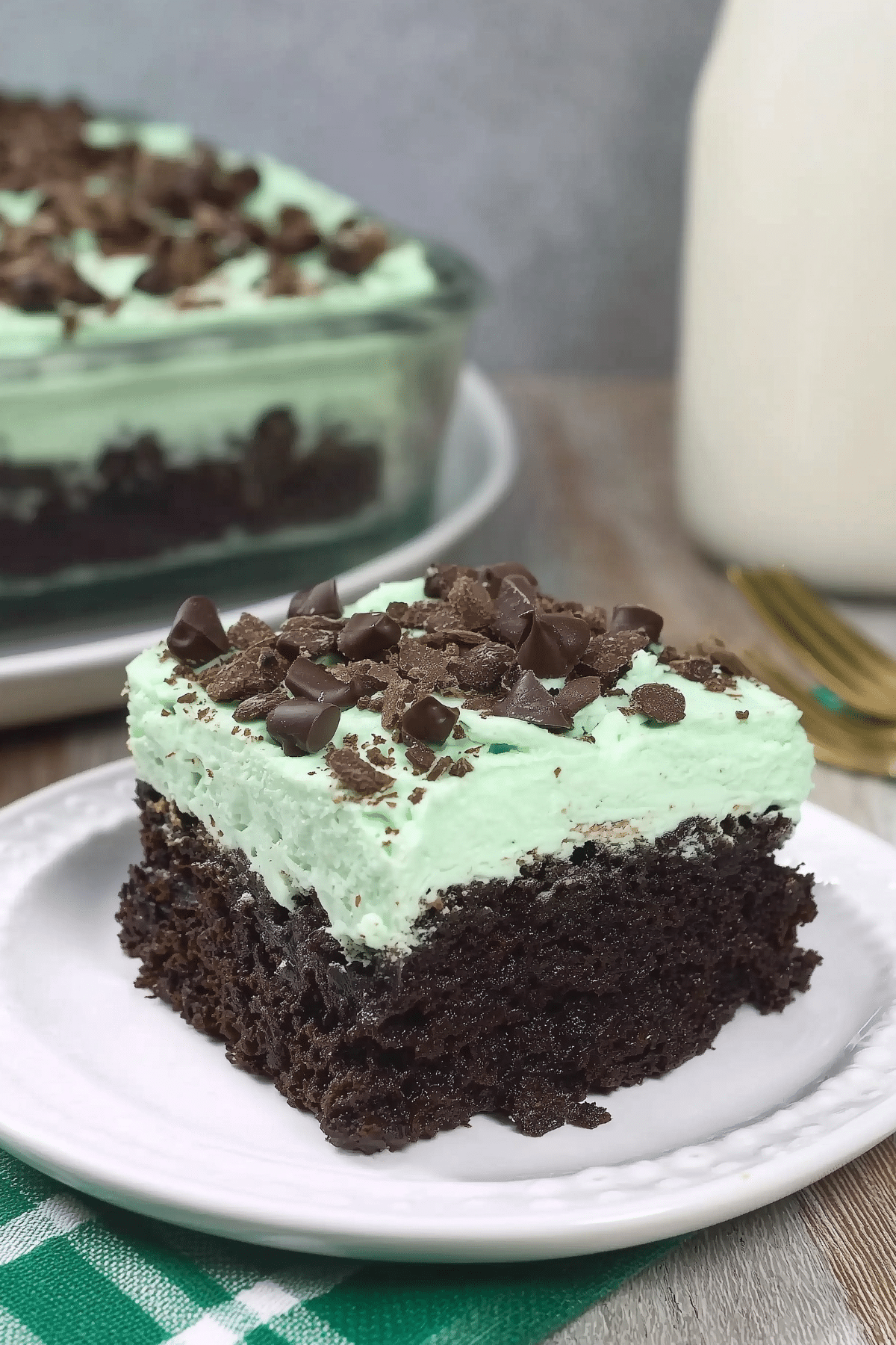Andes Mint Poke Cake topped with mint whipped cream and chopped Andes candies
