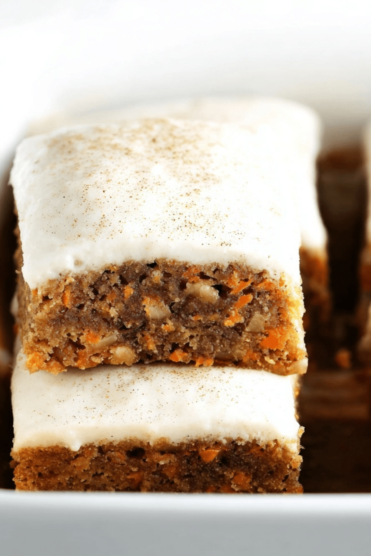 carrot cake bars topped with cream cheese frosting