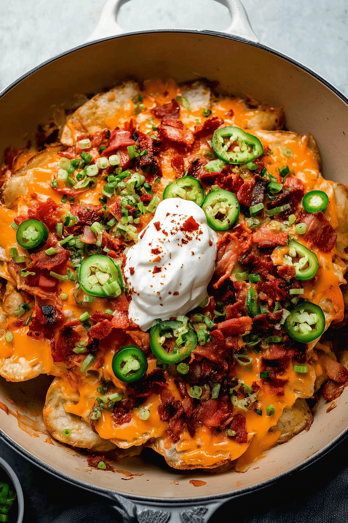 Irish Nachos topped with melted cheese, bacon, and green onions